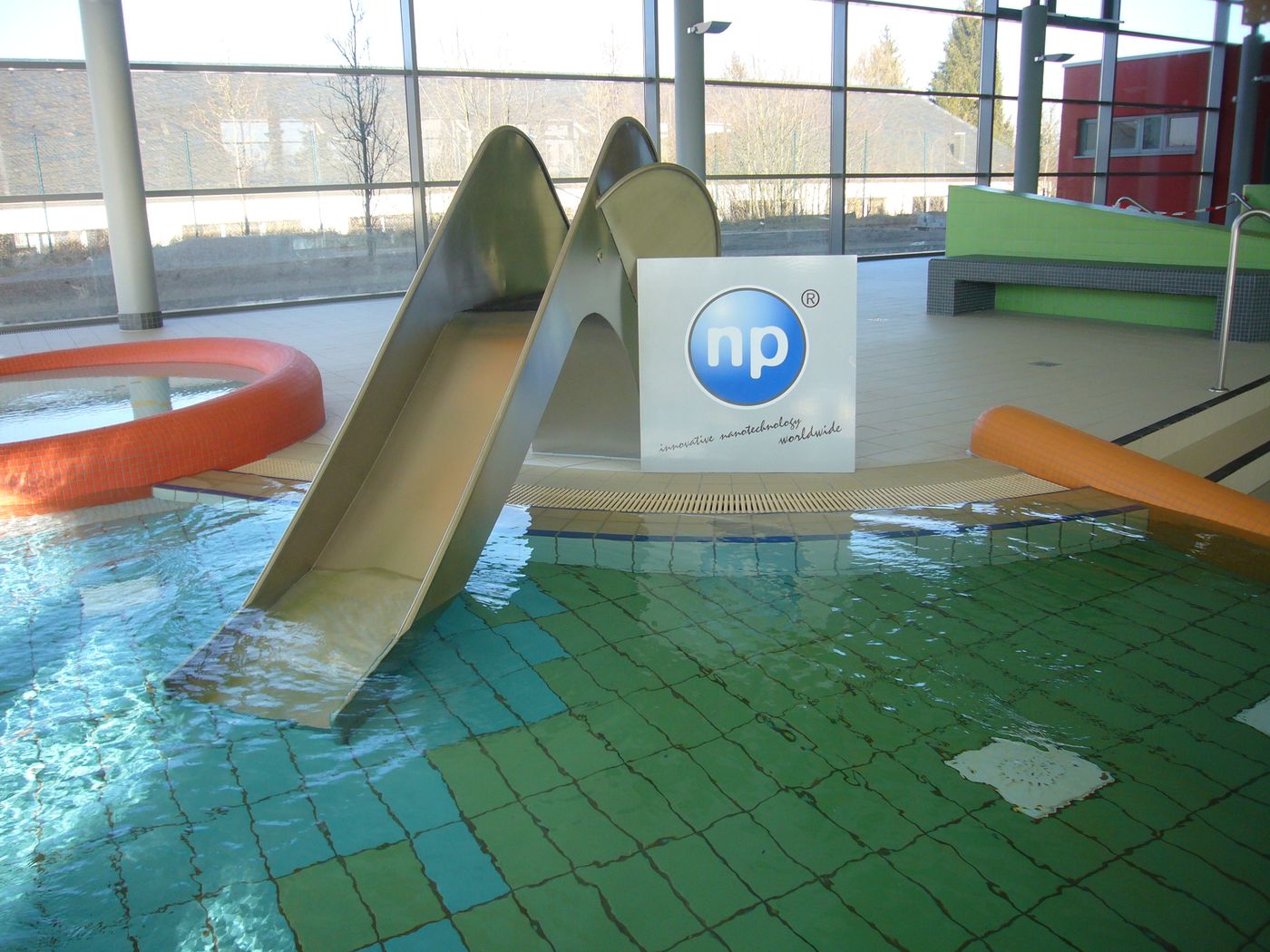 Indoor pool with treated slide